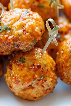 small appetizers with toothpicks are arranged on a plate