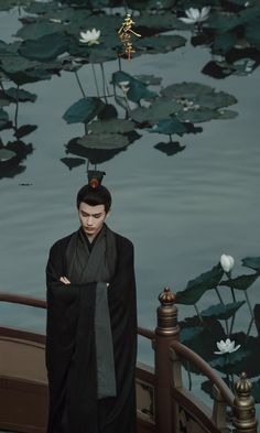 a man standing in front of water lilies