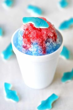 a cup filled with red, white and blue jello on top of a table