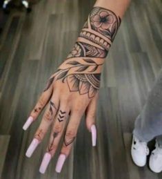 a woman's hand with tattoos on it