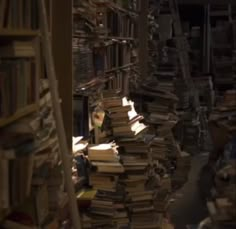 a room filled with lots of books and piles of them