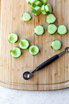 sliced cucumbers on a cutting board with a knife