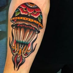 a colorful jellyfish tattoo on the arm