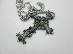 This Gothic cross necklace is an handmade pewter sculpture orned with an Austrian Swarovski or a real gem (My fav is the Black star Diopside, seriously) This gothic necklace is sold with a stainless steel chain of 18'' or 24'', if you would like to have a different length for the chain, you can write the desired length in the private note section when ordering :) This is a Gothic cross of 7cm This gothic cross necklace is a pewter sculpture of my own creation, i create and work the metal by myse Medieval Jewelry For Halloween Gift, Silver Cross Jewelry For Halloween, Gothic Cross Pendant Jewelry Gift, Gothic Cross Jewelry Gift, Gothic Cross Jewelry As Gift, Gothic Cross Jewelry For Gifts, Gothic Ankh Jewelry For Gift, Handmade Gothic Cross Pendant Necklace, Medieval Engraved Cross Jewelry