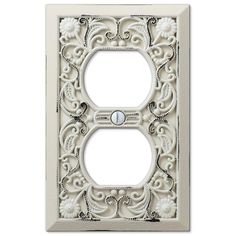 a decorative light switch plate with an ornate design on the front and back cover in white