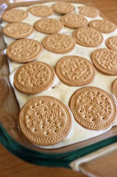 there are cookies on top of the cake in the glass baking dish, ready to be eaten