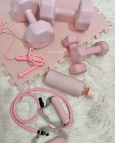 pink gym equipment laid out on a white rug