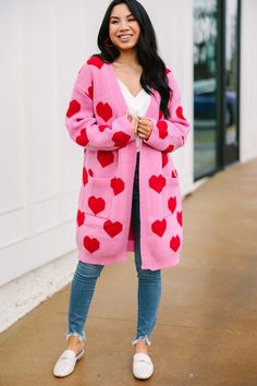 We are looking at you, girl! We know this cardigan is going to look so good on you! That heart print is so much fun and we love how bold it is! This cardigan is going to look great now with jeans and then later with shorts! Plus, that oversized fit is super comfy! This cardigan features long sleeves, pockets, and a heart print. 
Material has a generous amount of stretch.Cindy is wearing the small. Knee Length Cardigan, Heart Cardigan, Floral Cocktail Dress, Black Tie Dress, Long Sleeve Outerwear, Two Piece Swimwear, Cardigan Outfits, Friend Outfits, Romper With Skirt