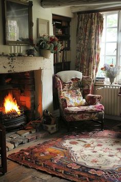 a living room filled with furniture and a fire place next to a window covered in curtains