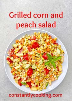 grilled corn and peach salad on a white plate with the words, grilled corn and peach salad