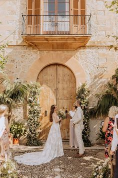 a couple getting married in front of an old building