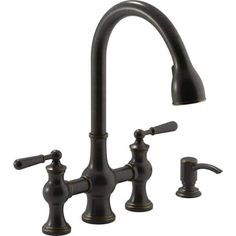 an antique style kitchen faucet with two handles and side sprayers in oil rubbed bronze