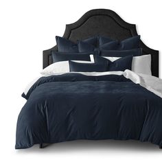 a bed with blue comforters and white pillows