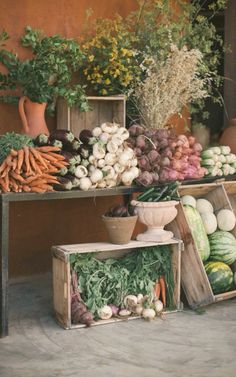 an assortment of vegetables on display in wooden crates