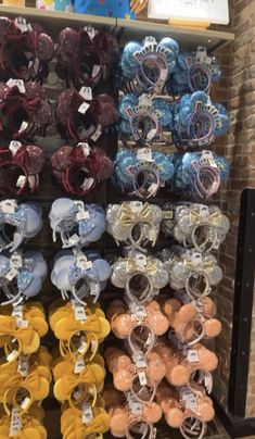 several pairs of baby shoes are on display in a store with other items for sale