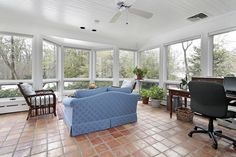 a living room filled with furniture and lots of windows