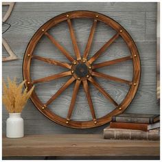 a wooden wheel on a shelf next to books