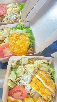 three takeout boxes filled with different types of food and salads on top of each other