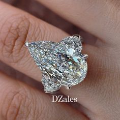 a woman's hand with a diamond ring on her finger and the words d'zales written below it