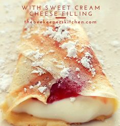 crepes with sweet cream and cheese filling on a white plate topped with powdered sugar