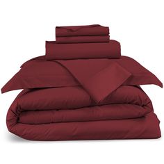 red sheets and pillows stacked on top of each other