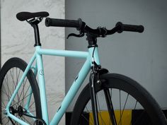 a blue bicycle parked in front of a building