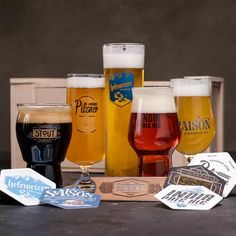 several different types of beer are lined up on a table