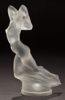 a white glass sculpture sitting on top of a table