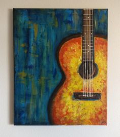 a painting of an acoustic guitar hanging on the wall