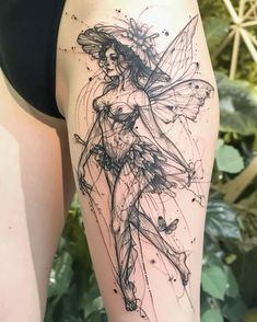 a woman's thigh with a tattoo design on her leg and an image of a fairy