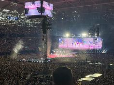 a large crowd at a concert in an arena