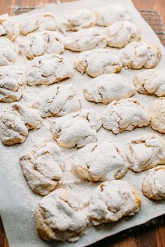 powdered sugar cookies on a baking sheet ready to be baked