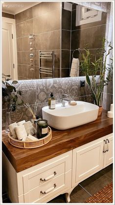 a white sink sitting on top of a wooden counter