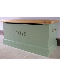 a green toy box with the word toys on it's front and side panels