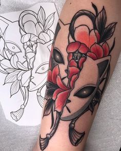 a woman's arm with a tattoo on it and flowers in the center,