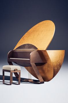 a wooden chair and ottoman sitting next to each other on a white floor with a gray background