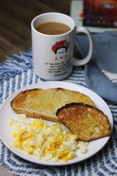 an egg salad and toast on a white plate next to a cup of coffee