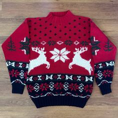 a red sweater with reindeers and snowflakes on it