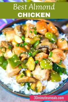 a bowl filled with chicken and vegetables on top of white rice in a blue bowl