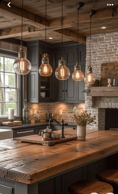 a kitchen island with lights hanging from it's ceiling and an oven in the background