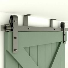 an open green barn door with metal hardware