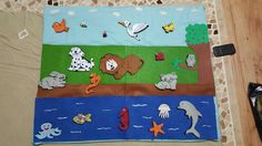 a child's play mat with animals and fish on it