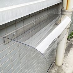 a white toilet sitting on the side of a building