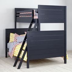 a bunk bed with two ladders on the bottom and yellow pillows on the top