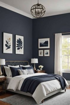 a bedroom painted in dark blue and white with pictures on the wall above the bed