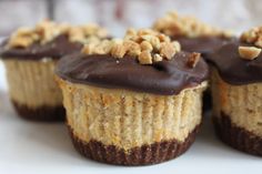 several cupcakes with chocolate frosting and nuts on top