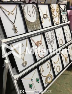 many different necklaces are on display in a jewelry store, and one is for sale