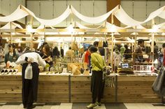 people are standing in line at an outdoor market