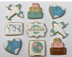 some cookies are decorated with different types of travel related items and luggage on the side