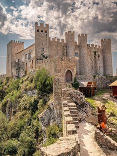 an old castle with stairs leading up to it